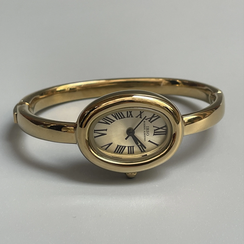 Aura Curve: Sculpted Oval Dial Bangle Watch in Gold