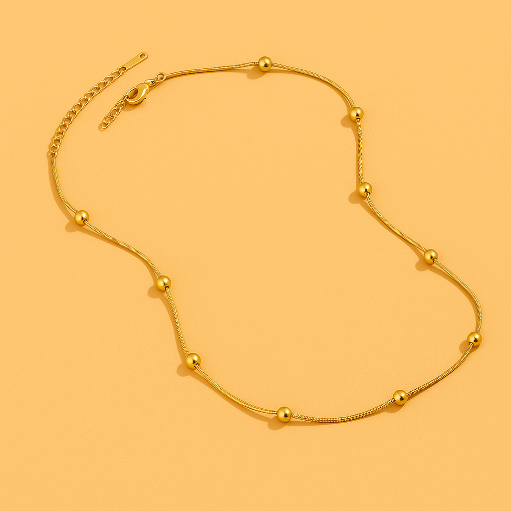 Refined snakebone necklace - Gold bead detail