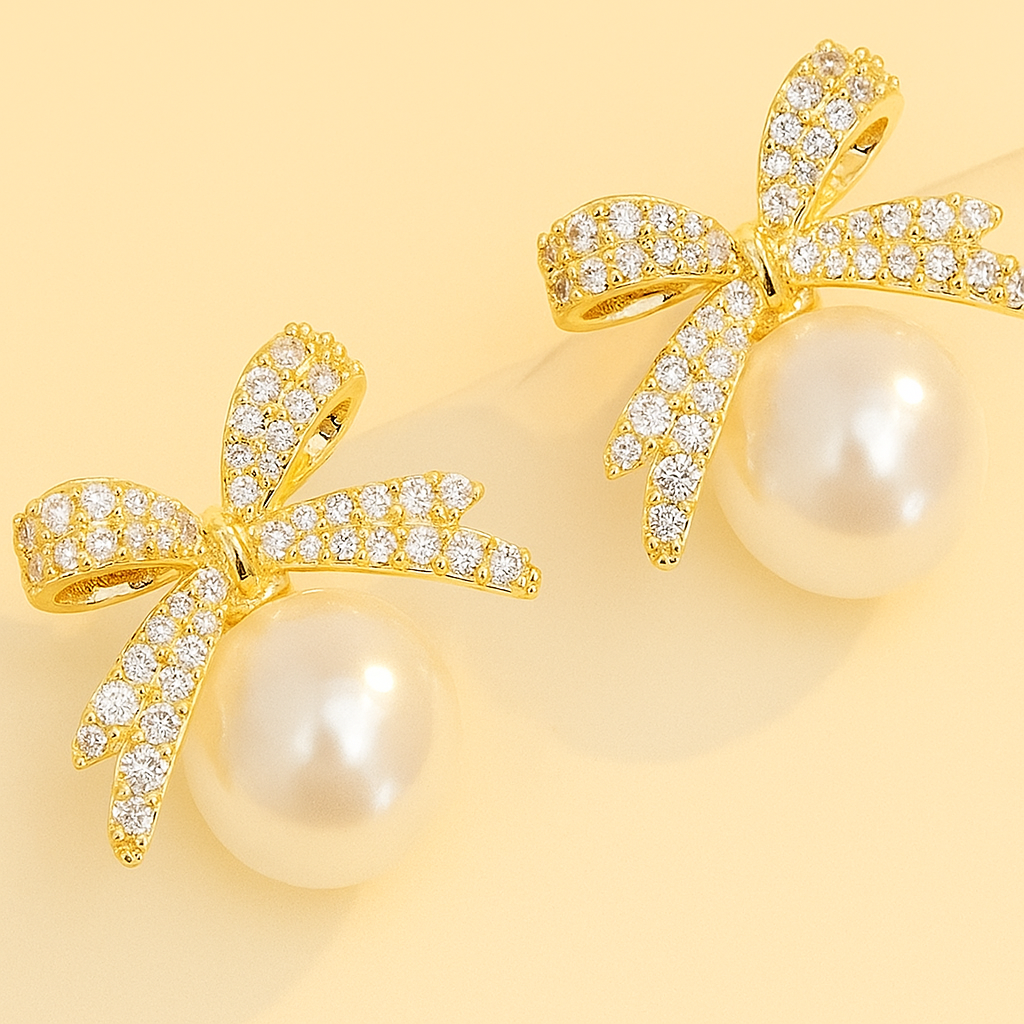 Ornate pearl earrings with bow embellishment