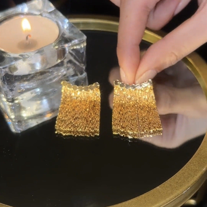 Long earrings with curved bar and tassel