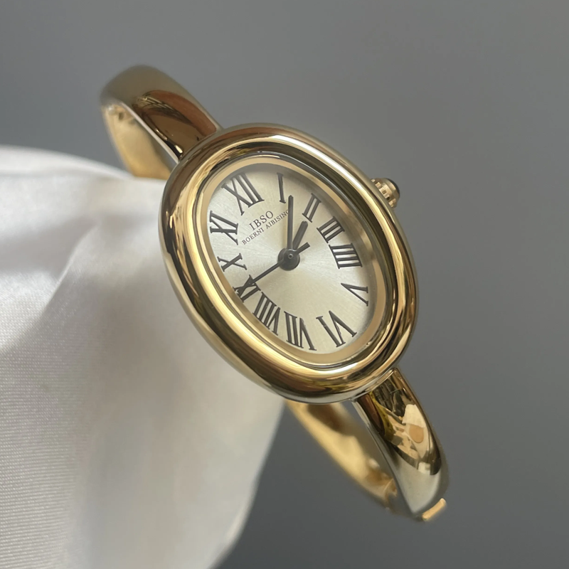 Aura Curve: Sculpted Oval Dial Bangle Watch in Gold